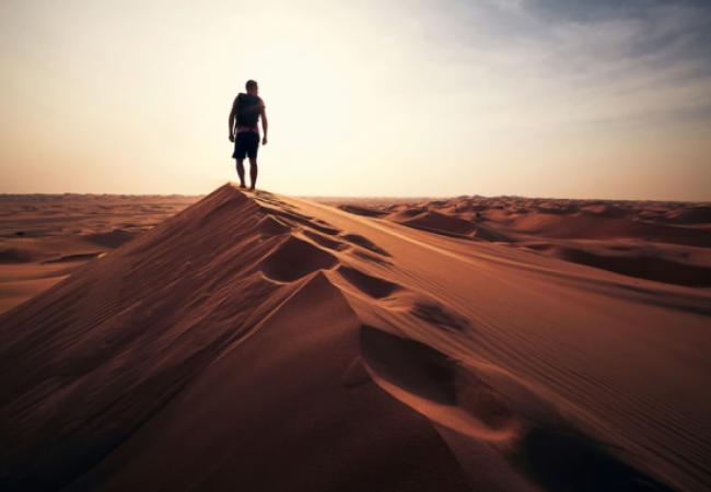 Man walking along a dune