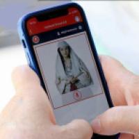 Cellphone held by someone using Albiania's AI minister portal